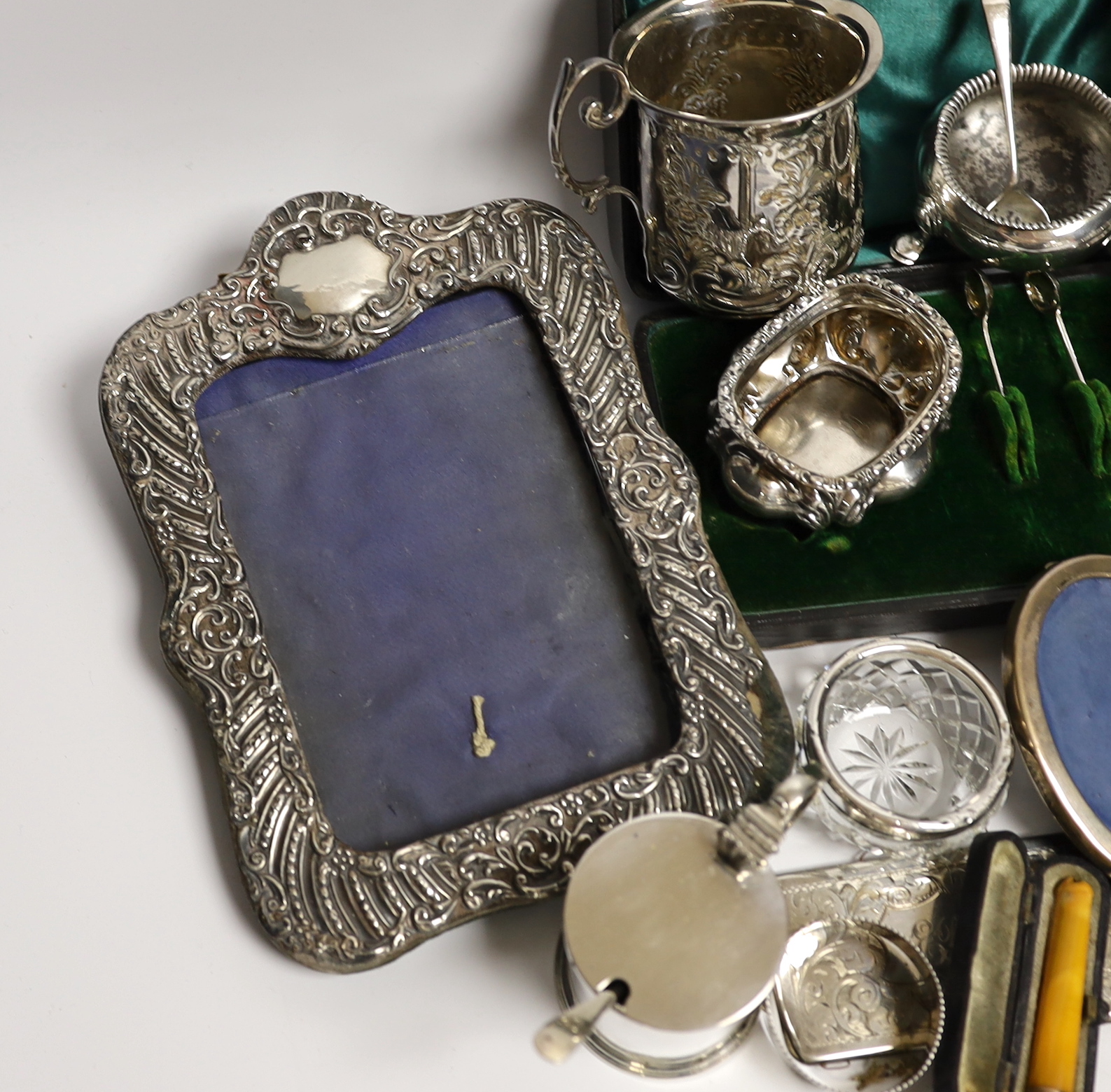 Sundry small silver and white metal items including Edwardian Christening mug, four mounted photograph frames, napkin rings, card cases, bun pepperette etc.